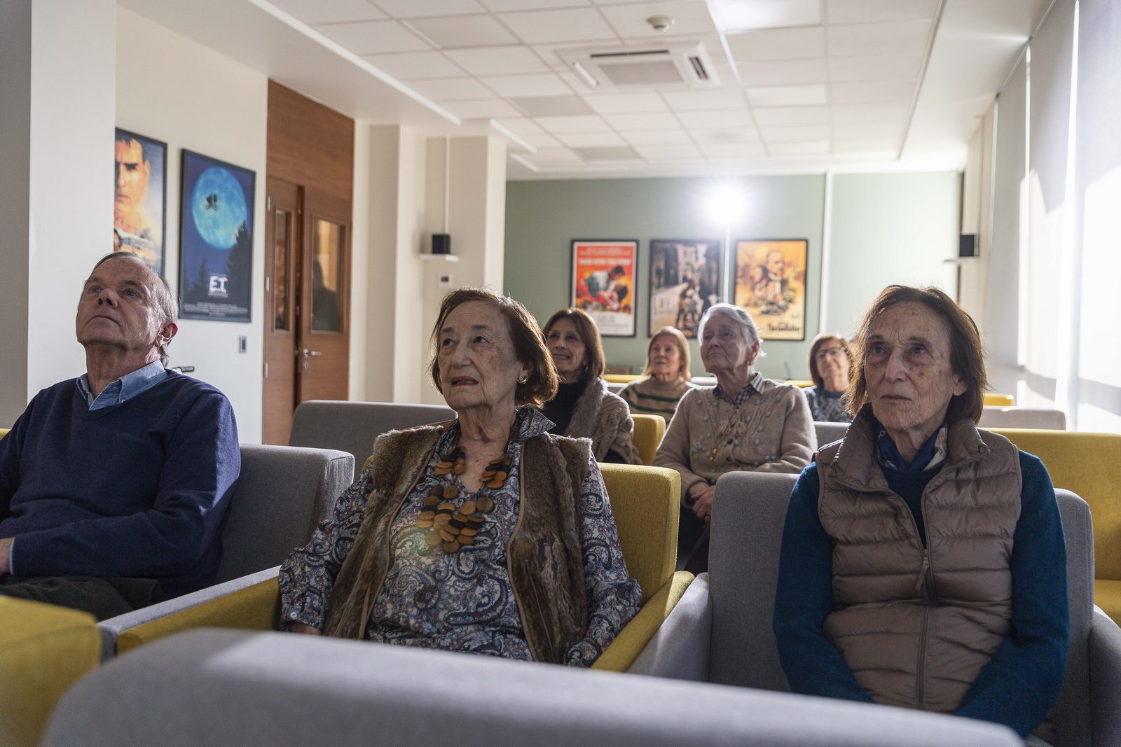 Residentes viendo una película en la sala de cine